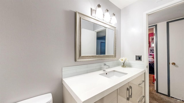 bathroom featuring toilet and vanity