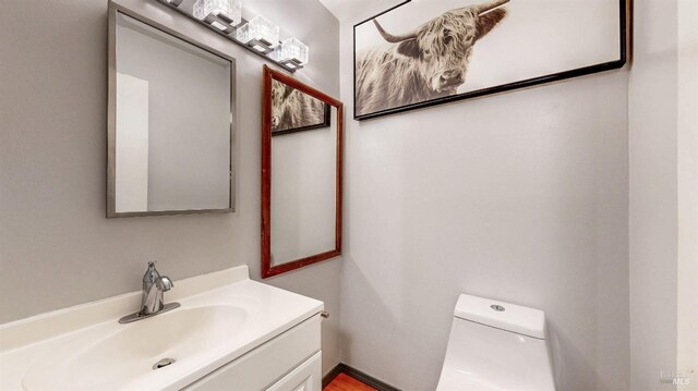 bathroom with toilet and vanity