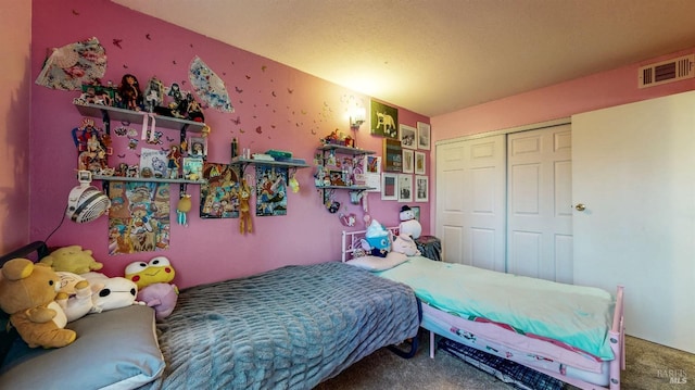 carpeted bedroom with a closet and visible vents