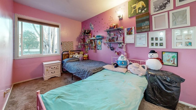 bedroom featuring baseboards and carpet