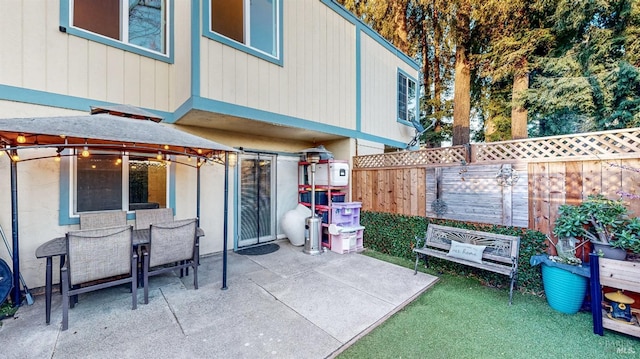 view of patio with outdoor dining area and fence