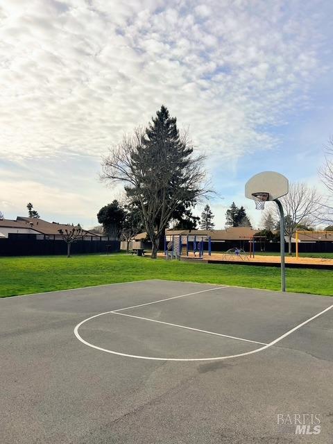 view of sport court featuring a yard and community basketball court