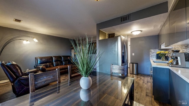 dining area featuring dark wood finished floors and visible vents