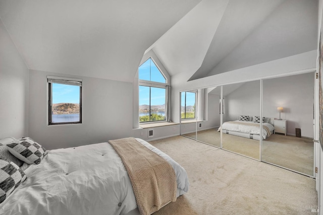 bedroom with multiple windows, carpet floors, and lofted ceiling