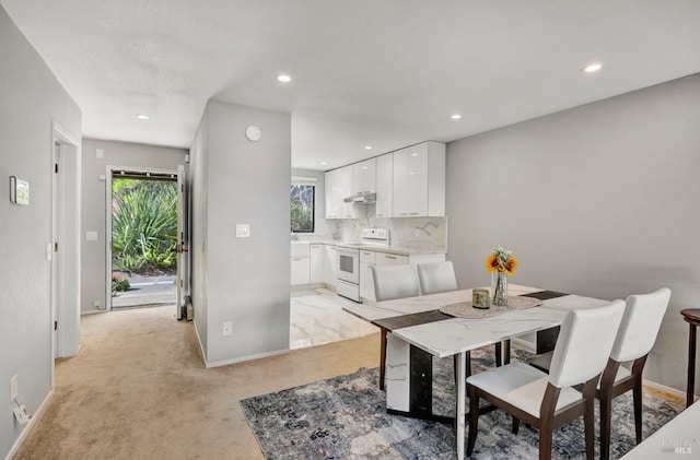 dining area featuring light colored carpet