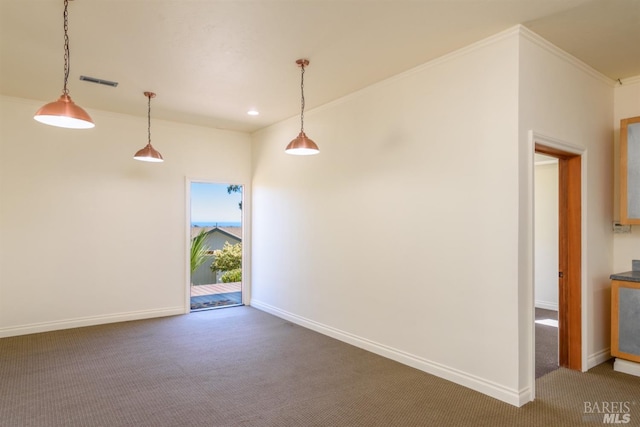 carpeted empty room featuring crown molding