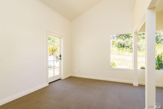 unfurnished room with carpet flooring, crown molding, and vaulted ceiling