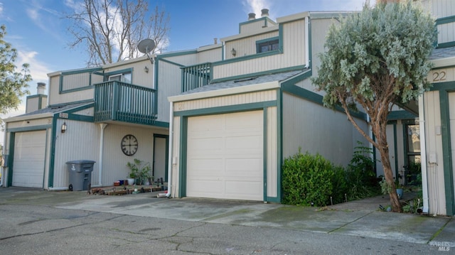 townhome / multi-family property with a balcony and a garage