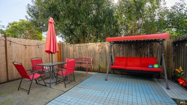 view of patio / terrace featuring outdoor dining area and a fenced backyard