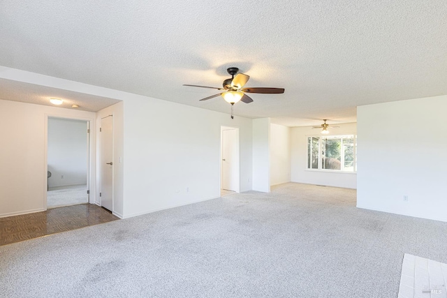 empty room with ceiling fan, a textured ceiling, and light carpet