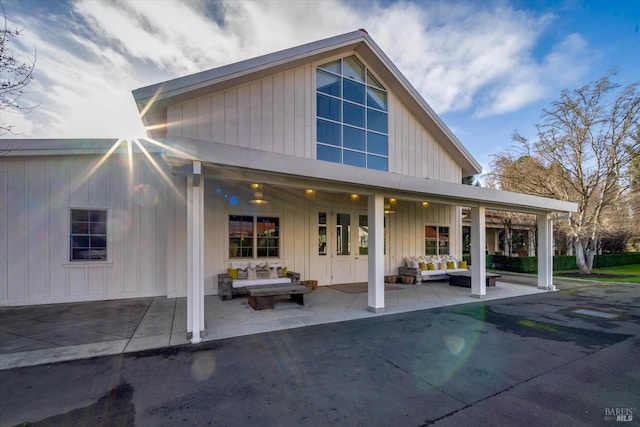 rear view of house featuring outdoor lounge area, french doors, and a patio area