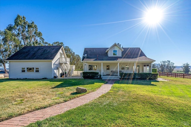 view of front of home with a front yard and a porch