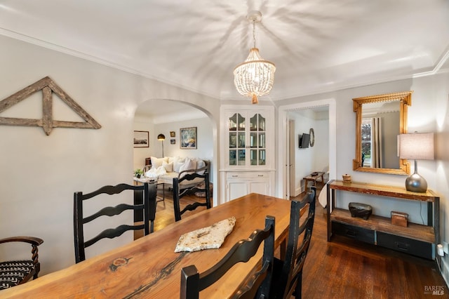 dining room with a notable chandelier and dark wood-type flooring