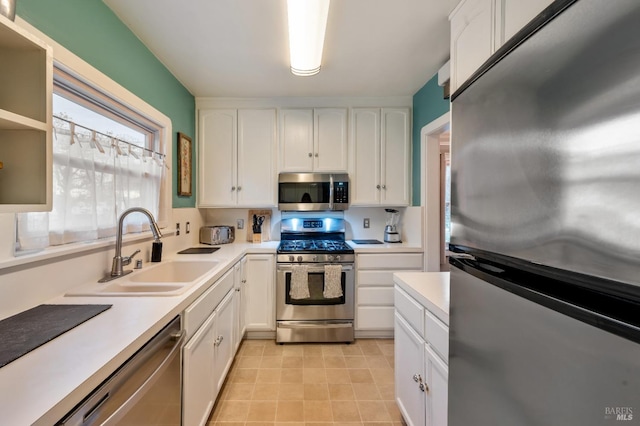 kitchen with white cabinets, sink, and stainless steel appliances