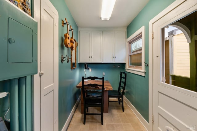 interior space featuring electric panel and stacked washing maching and dryer