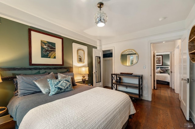 bedroom featuring dark hardwood / wood-style flooring and a closet