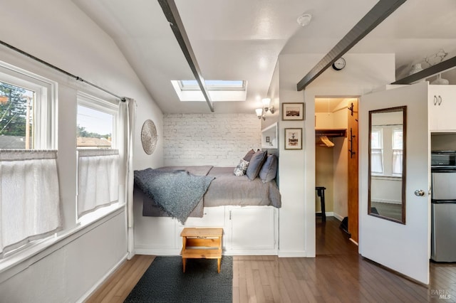 sitting room with vaulted ceiling with skylight and light hardwood / wood-style floors