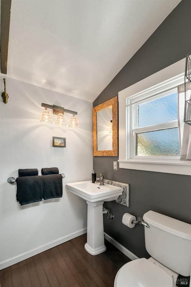 bathroom with toilet, wood-type flooring, and lofted ceiling