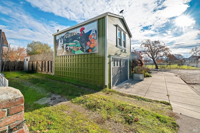 view of side of property featuring a yard and a garage