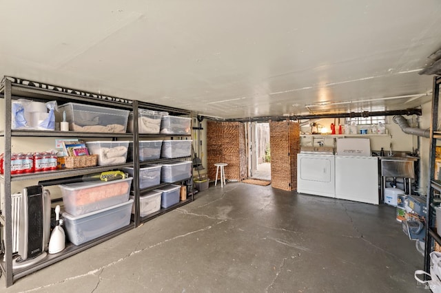 storage area with separate washer and dryer and sink