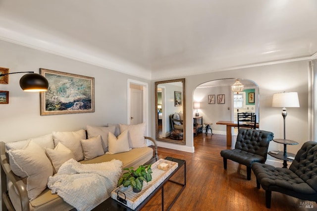 living room with dark hardwood / wood-style flooring and ornamental molding