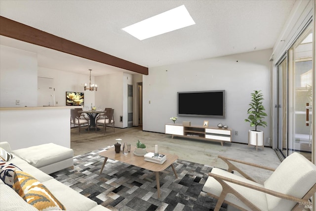 living room featuring a skylight, beam ceiling, and an inviting chandelier