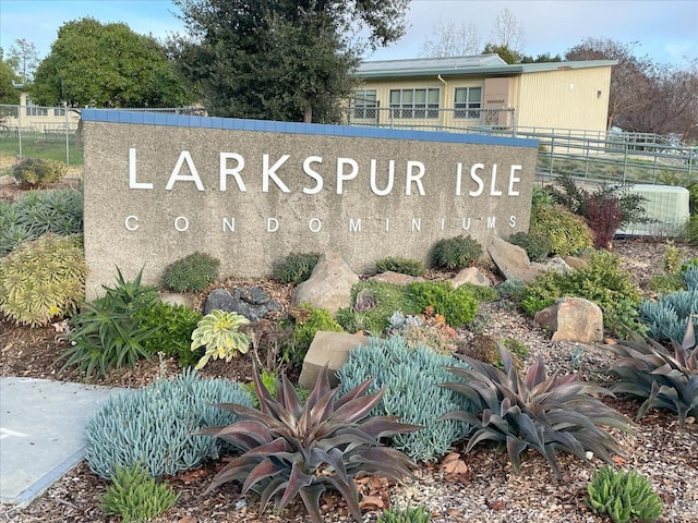 community / neighborhood sign featuring fence