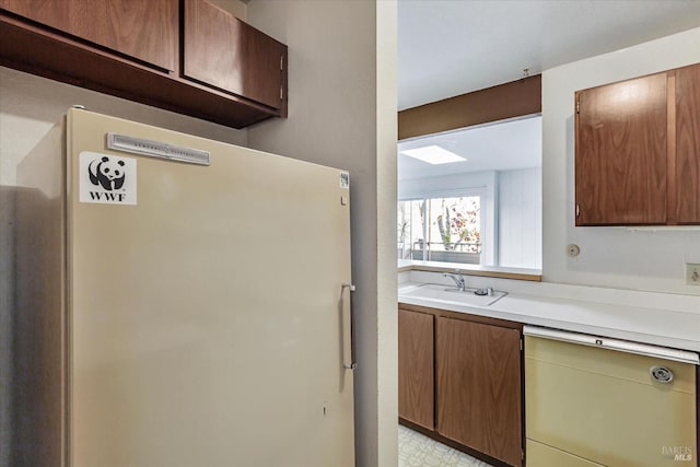 kitchen featuring sink and white fridge