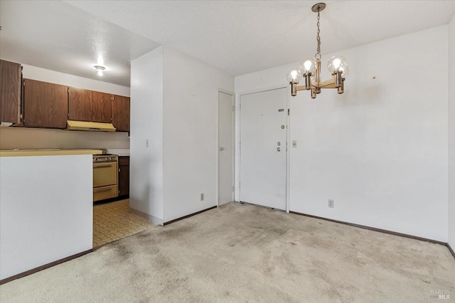 unfurnished dining area featuring light colored carpet and a chandelier