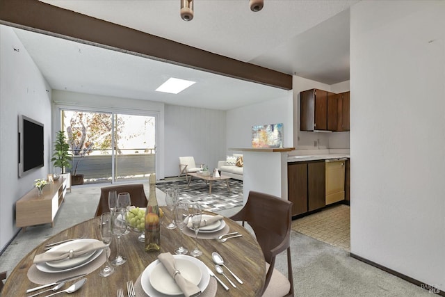 carpeted dining room featuring beamed ceiling