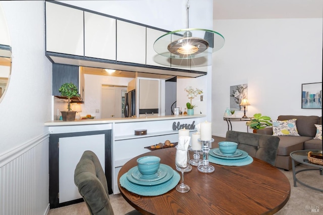 dining space featuring light colored carpet