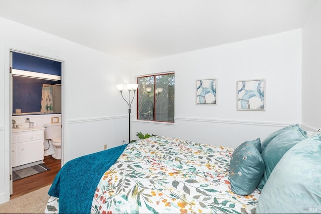 bedroom featuring wood-type flooring and ensuite bathroom