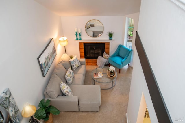 living room with carpet floors and a fireplace