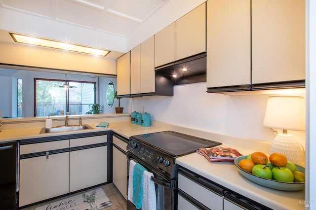 kitchen featuring black appliances, light tile patterned floors, sink, and white cabinetry