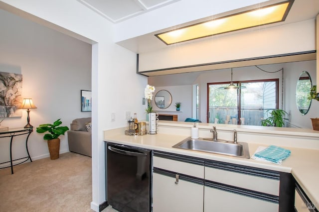 kitchen featuring light carpet, white cabinetry, dishwasher, hanging light fixtures, and sink