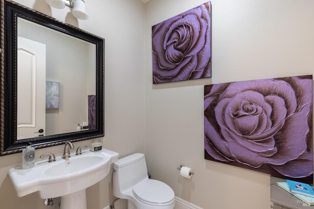 bathroom featuring sink and toilet