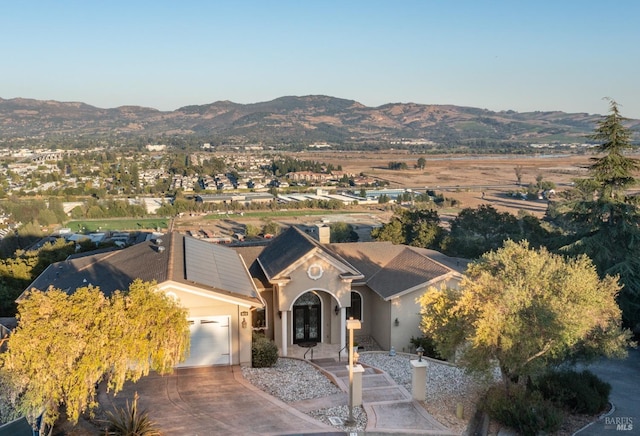 view of front of property with a mountain view and a garage