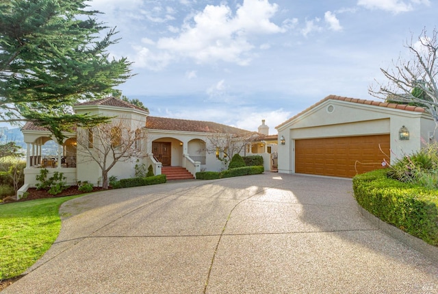 mediterranean / spanish house with a garage