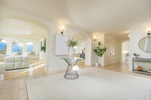 interior space with crown molding and light tile patterned flooring