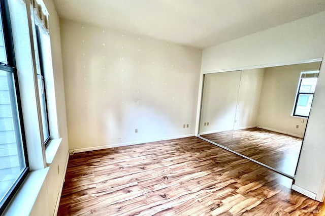 unfurnished bedroom featuring light wood-type flooring