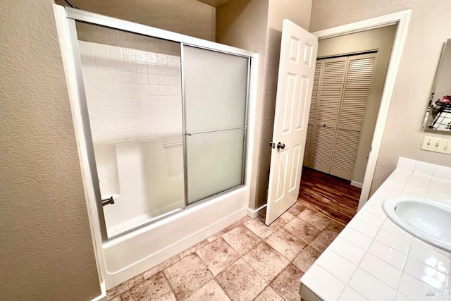 bathroom featuring vanity and enclosed tub / shower combo