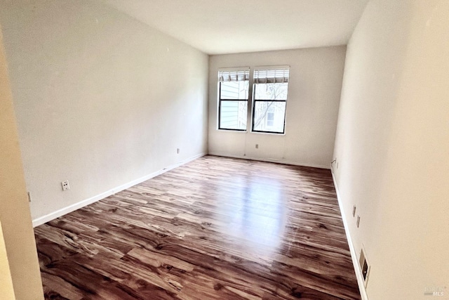 spare room with wood-type flooring