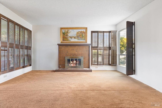 unfurnished living room with carpet flooring and a textured ceiling