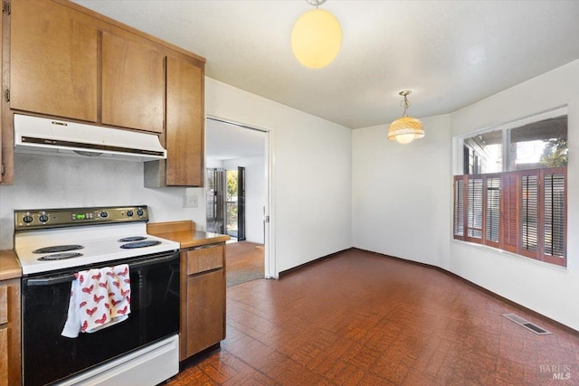 kitchen featuring electric stove and hanging light fixtures