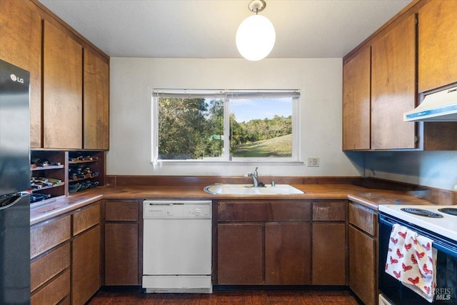 kitchen with stainless steel refrigerator, dishwasher, sink, electric stove, and exhaust hood