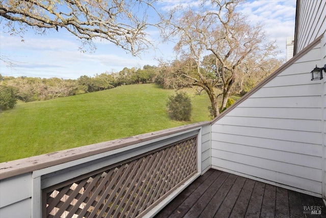 wooden terrace featuring a lawn