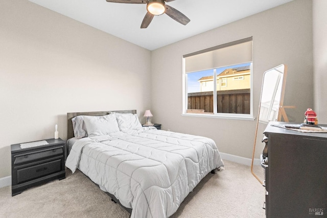 bedroom with light carpet and ceiling fan