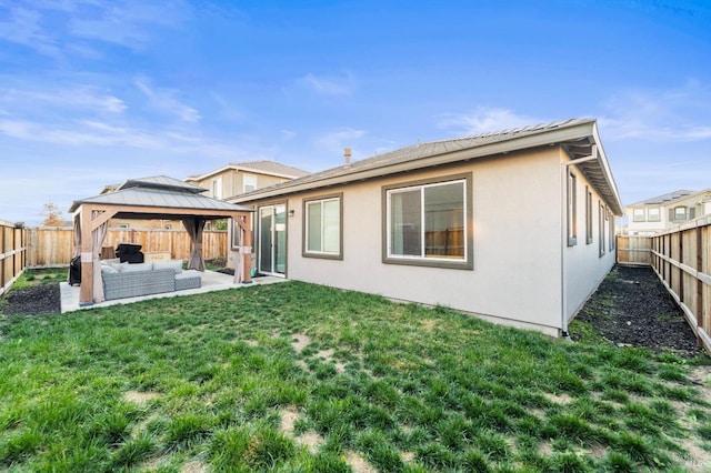 rear view of property featuring a gazebo, an outdoor hangout area, and a yard