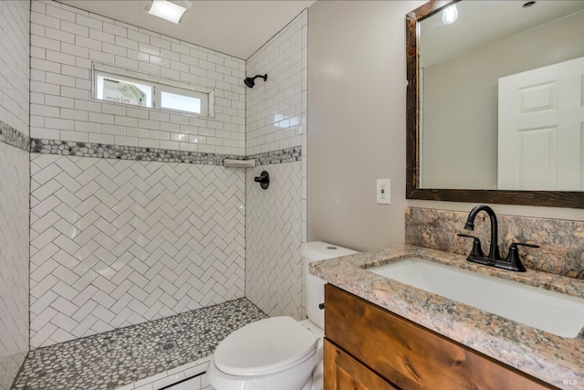 full bathroom featuring a stall shower, vanity, and toilet