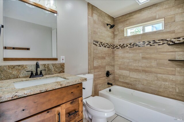 full bathroom with tile patterned flooring, vanity, toilet, and tiled shower / bath